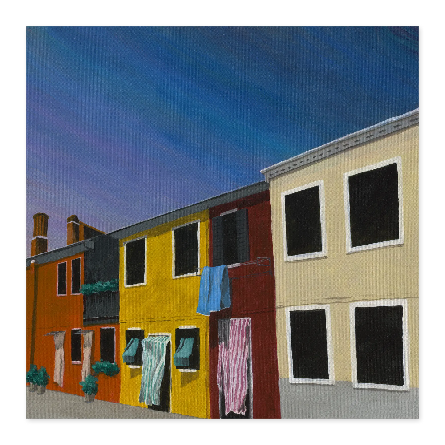 Colorful houses with clothes hanging out to dry against a blue sky.