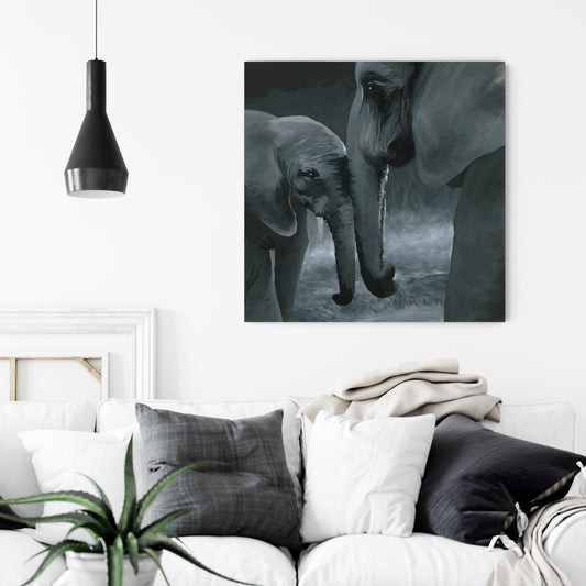 mother and baby elephant connecting with trunks