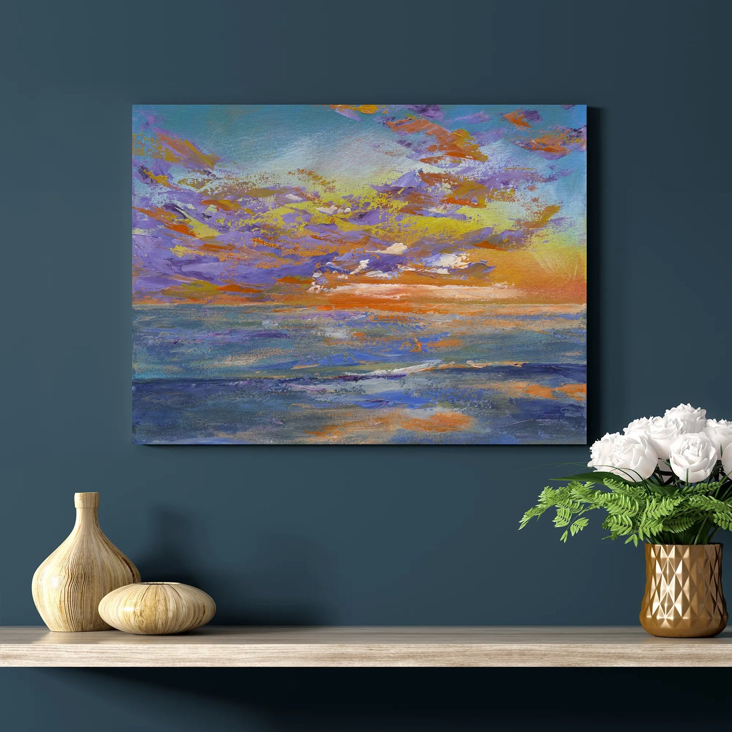 Colorful abstract painting of a sunset on a dark blue wall above a wooden shelf with decorative items.