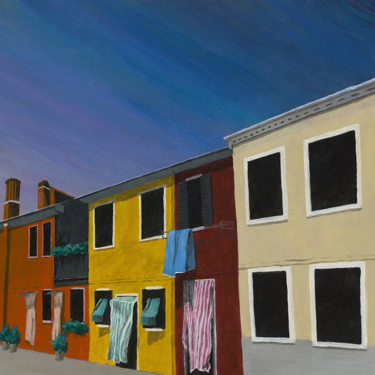 Colorful street scene with buildings and hanging laundry against a blue sky.