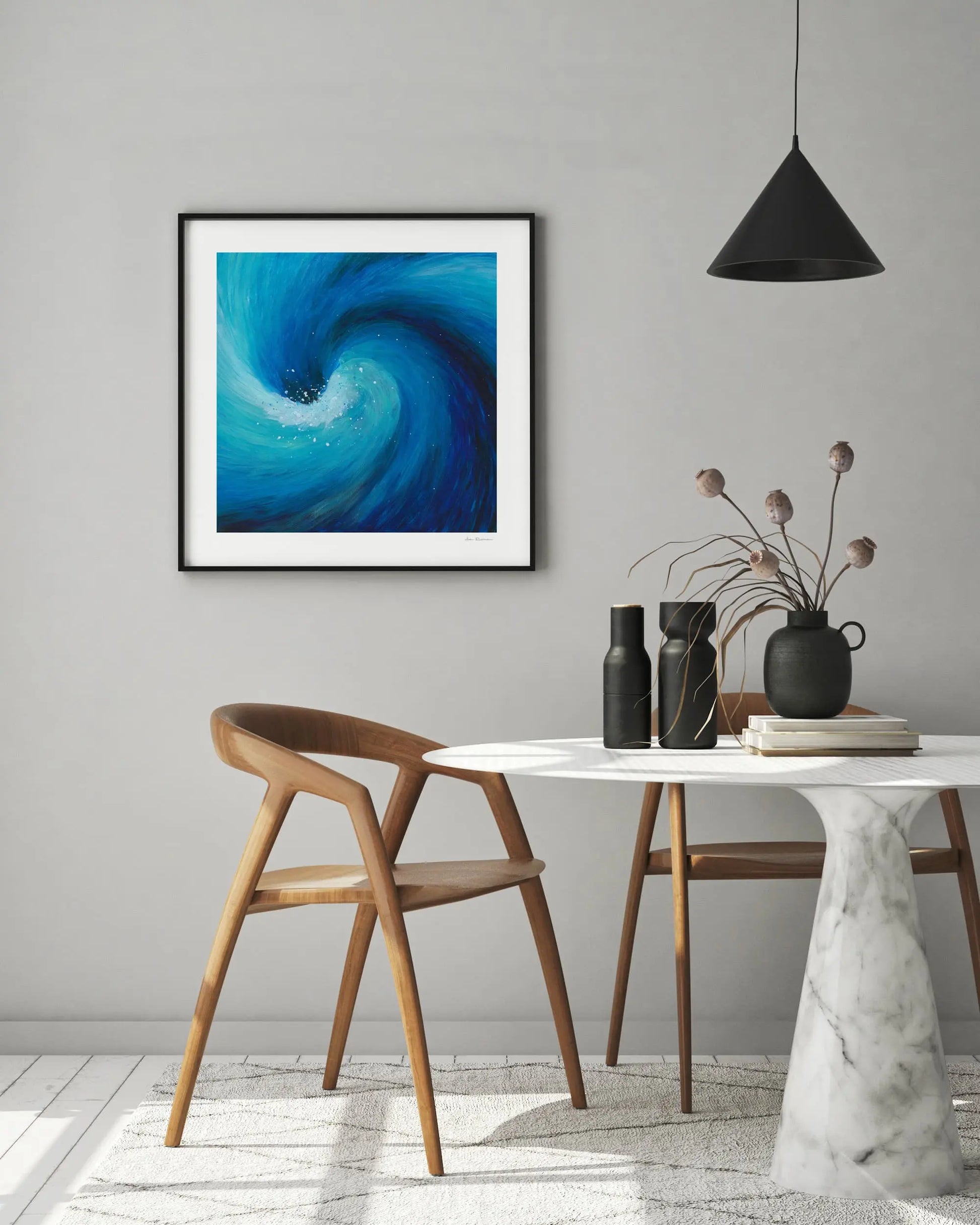 Modern interior with a dining table, chairs, and abstract artwork on the wall.