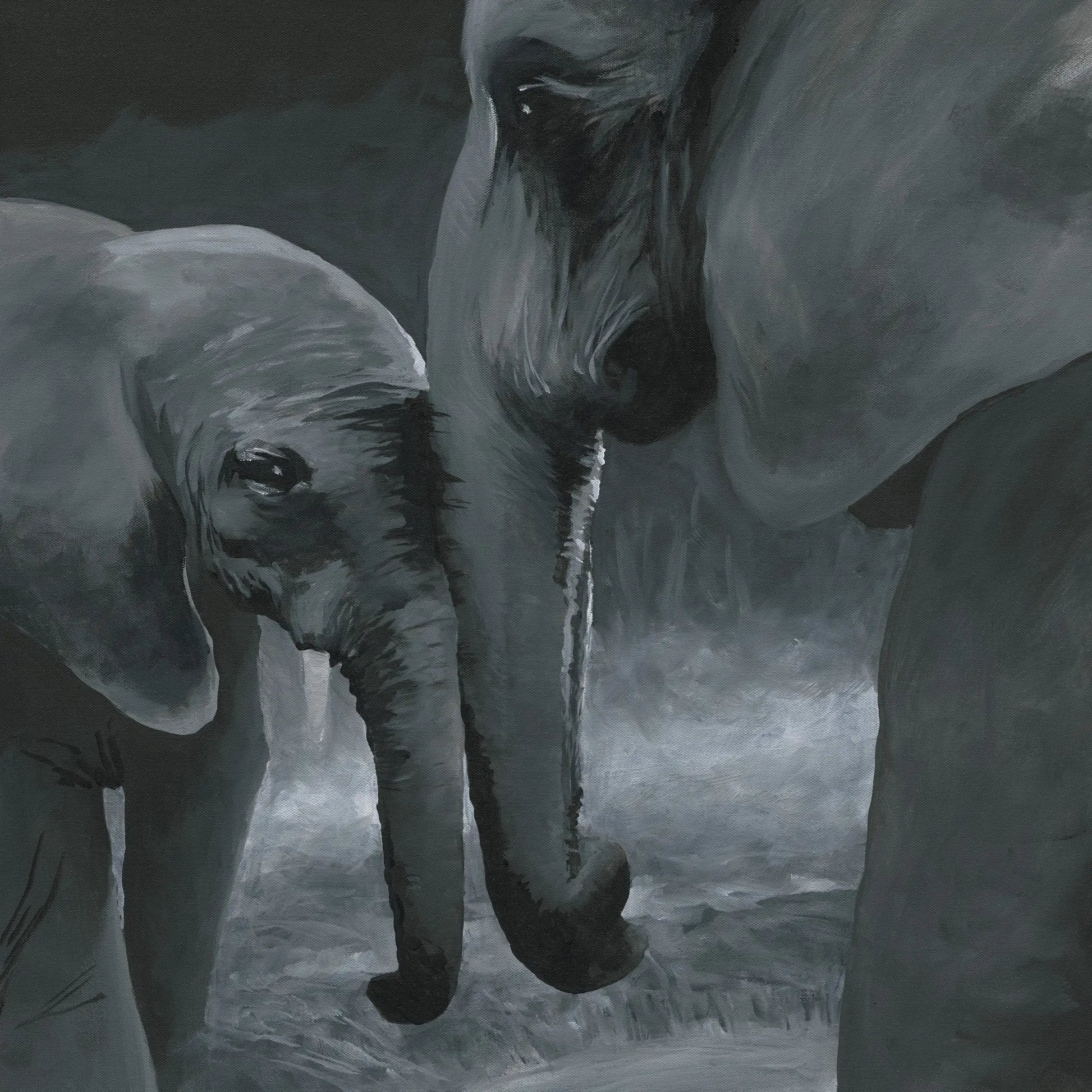 Two elephants interacting with each other in a misty landscape