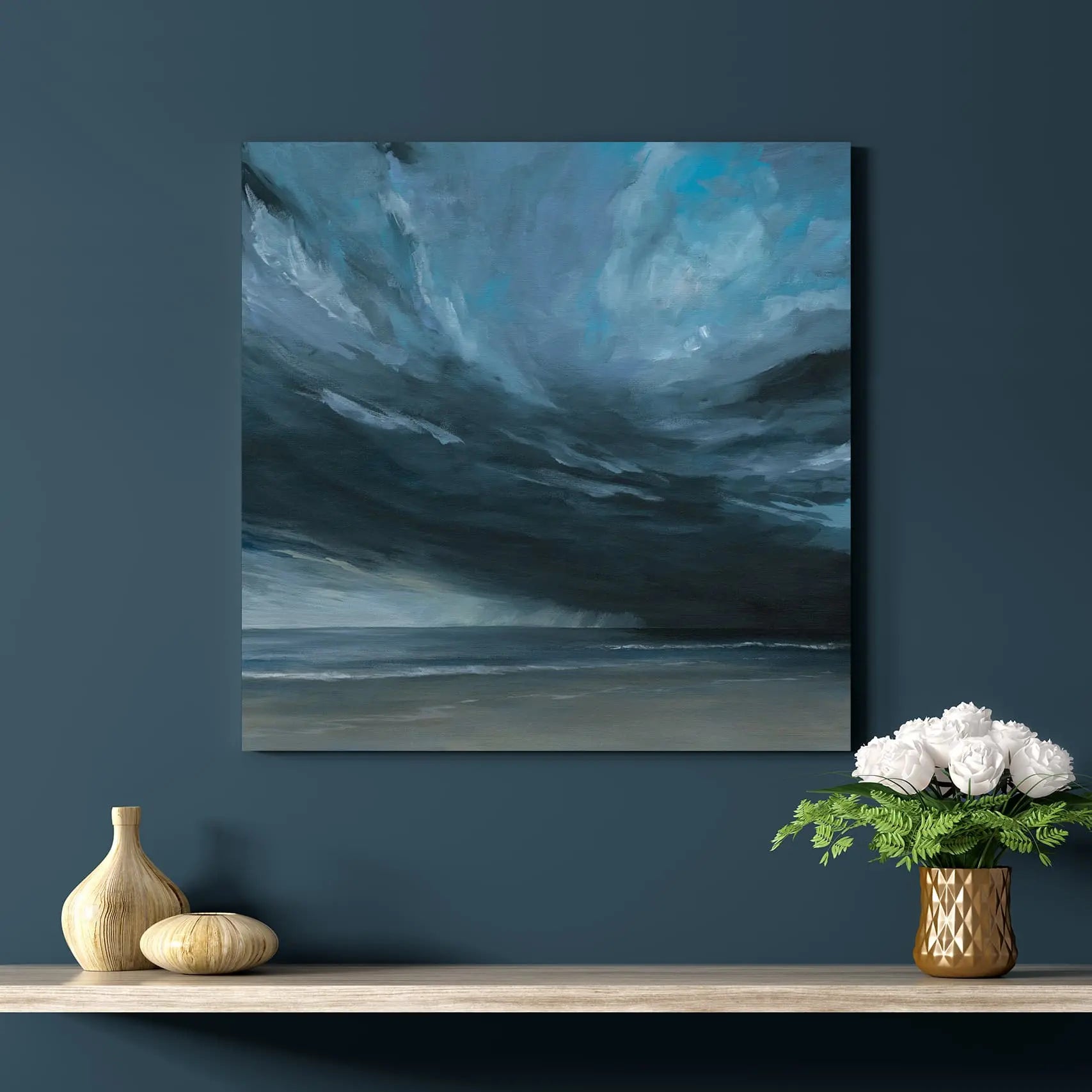 Abstract painting of swirling clouds on a dark blue wall above a shelf with decorative items.