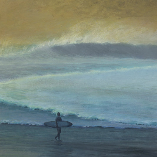 Surfer with a surfboard standing in the ocean waves during sunset.