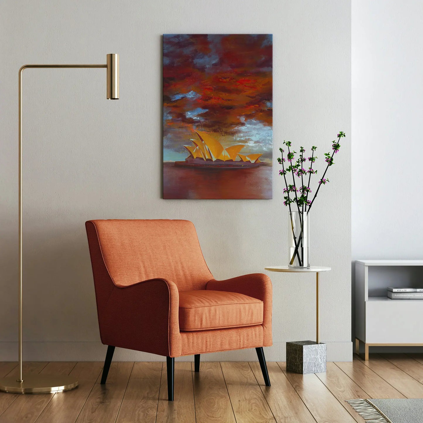 Orange armchair in a living room with a painting of the Sydney Opera House on the wall.