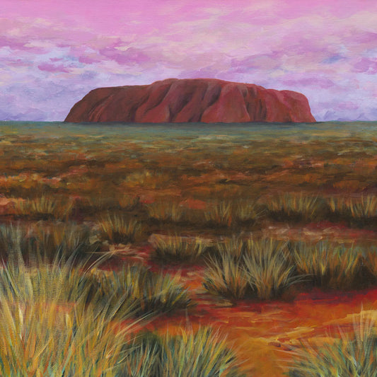 Painting of Uluru, a red rock formation in a grassy landscape with a pink sky.