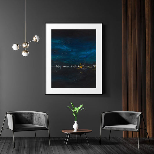 Modern living room with framed artwork, chairs, and a small table.