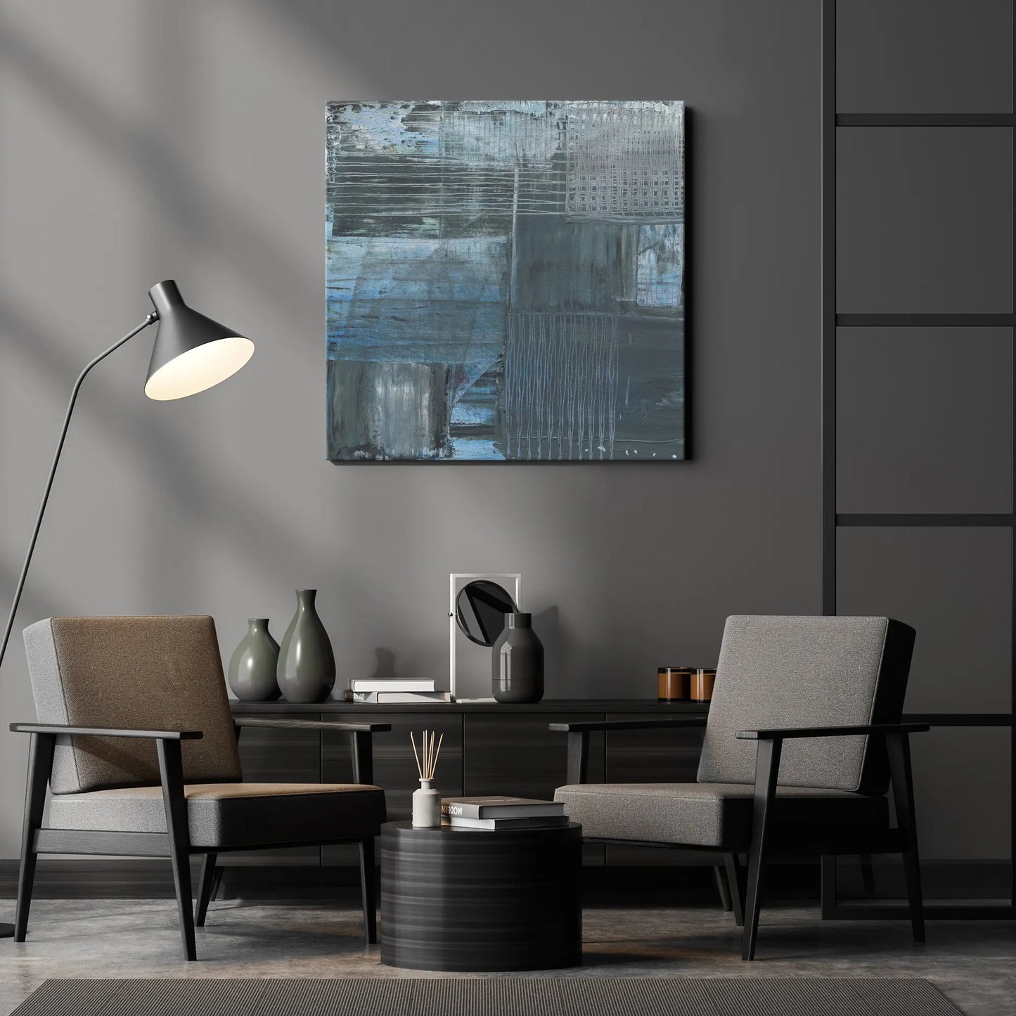 Modern living room with two chairs, a table, and abstract art on the wall.