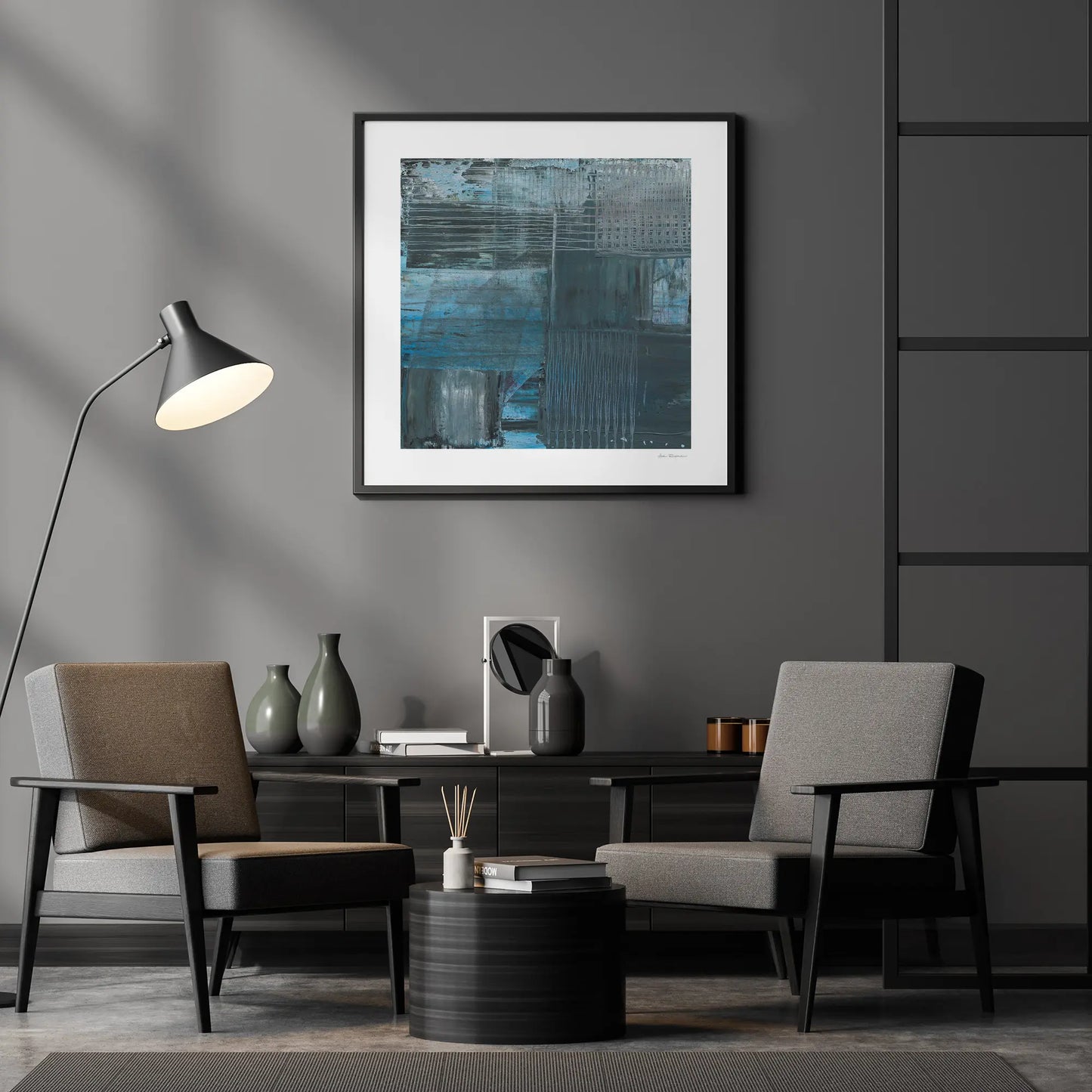 Modern living room with two chairs, a lamp, and a framed abstract painting on a gray wall.