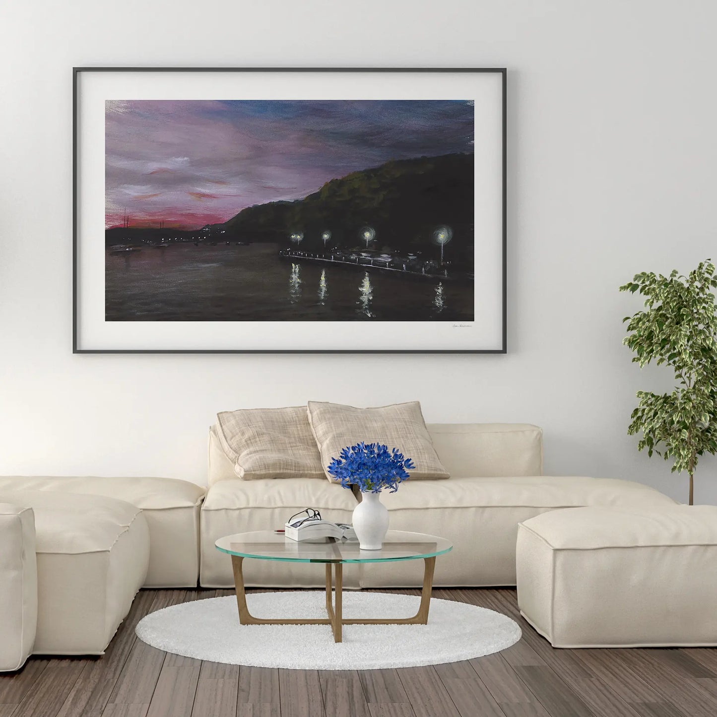 Framed artwork above a beige sofa in a living room
