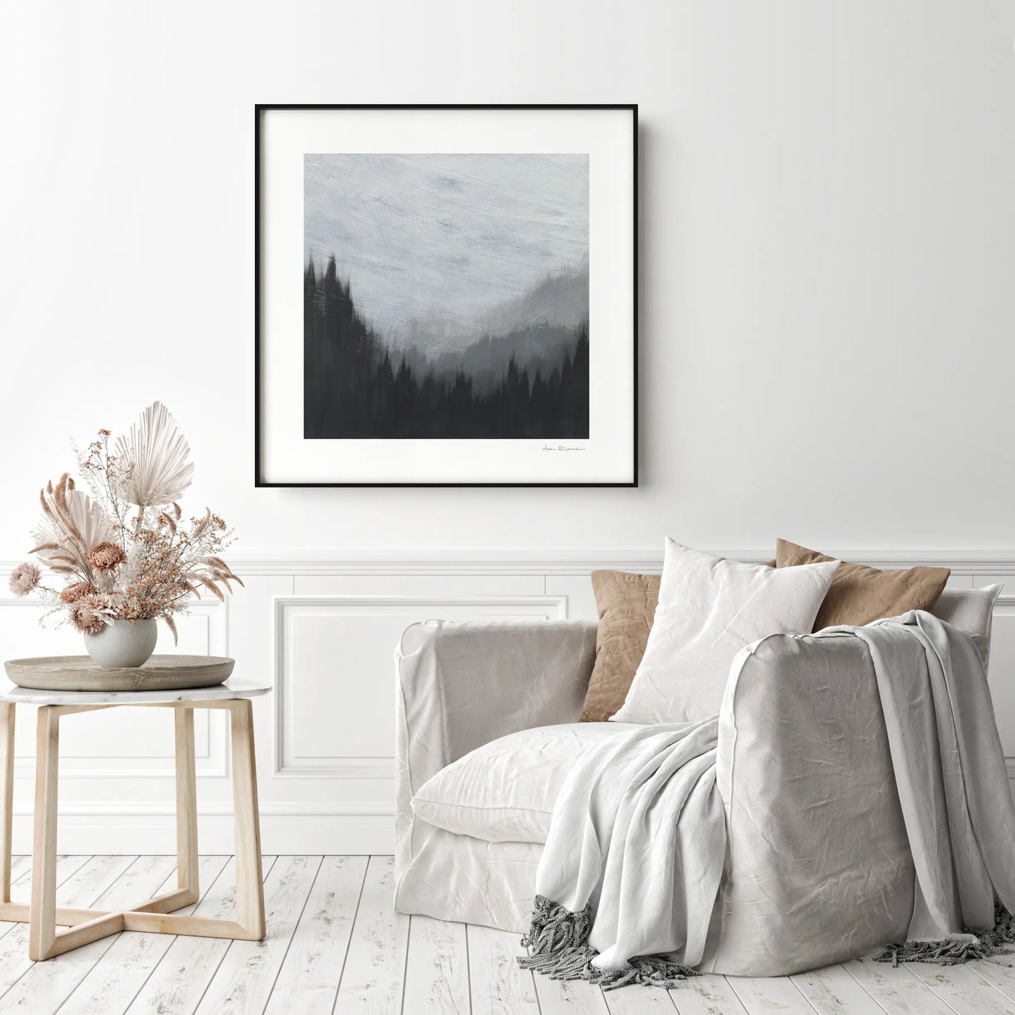 Living room with a sofa, side table, and framed artwork on the wall.