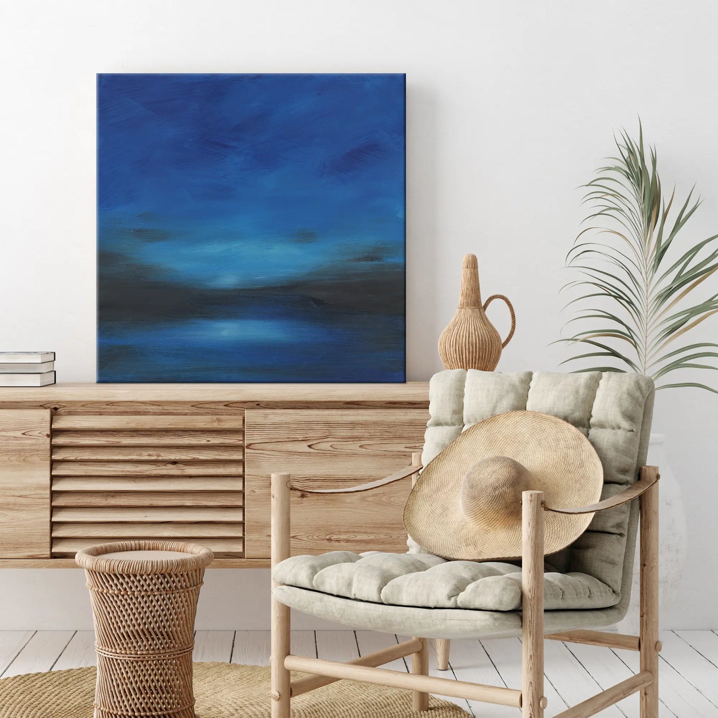 Modern interior with a wooden sideboard, chair, and abstract blue painting.