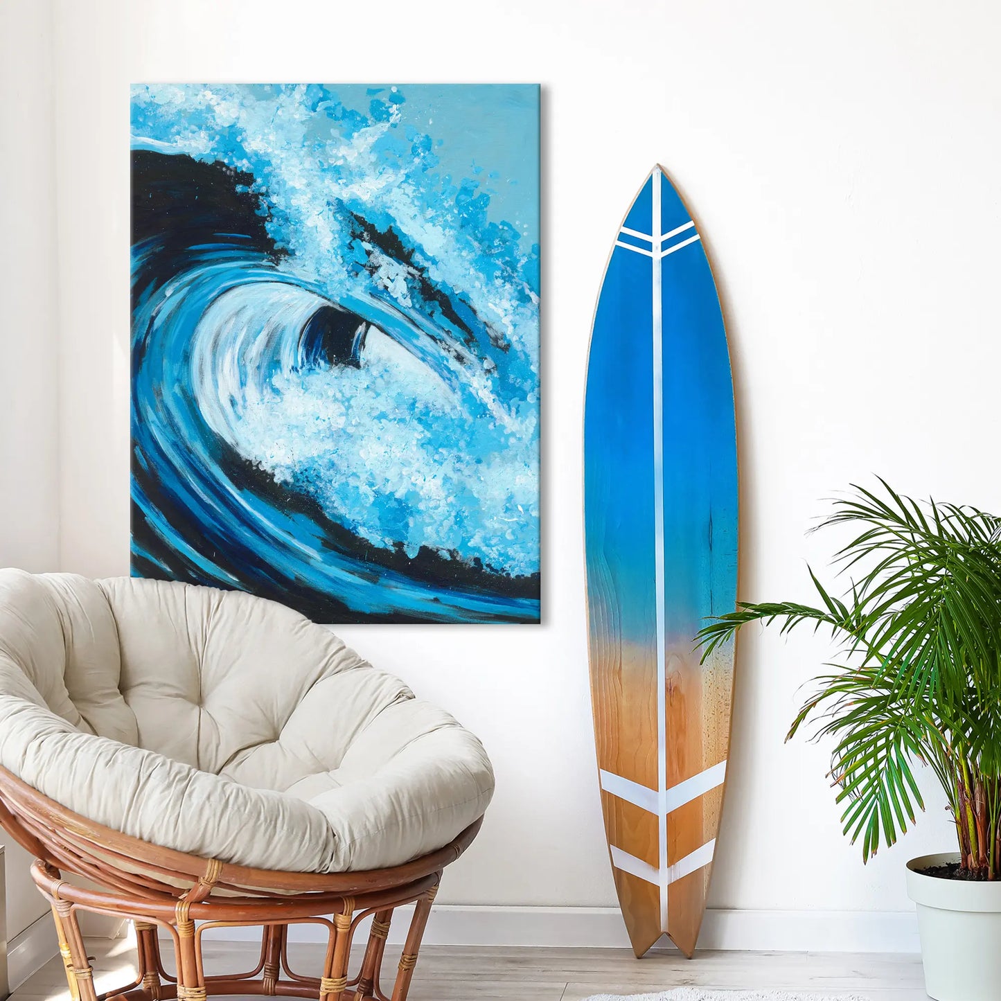 Surfboard with blue gradient design leaning against a wall next to a painting of a wave.